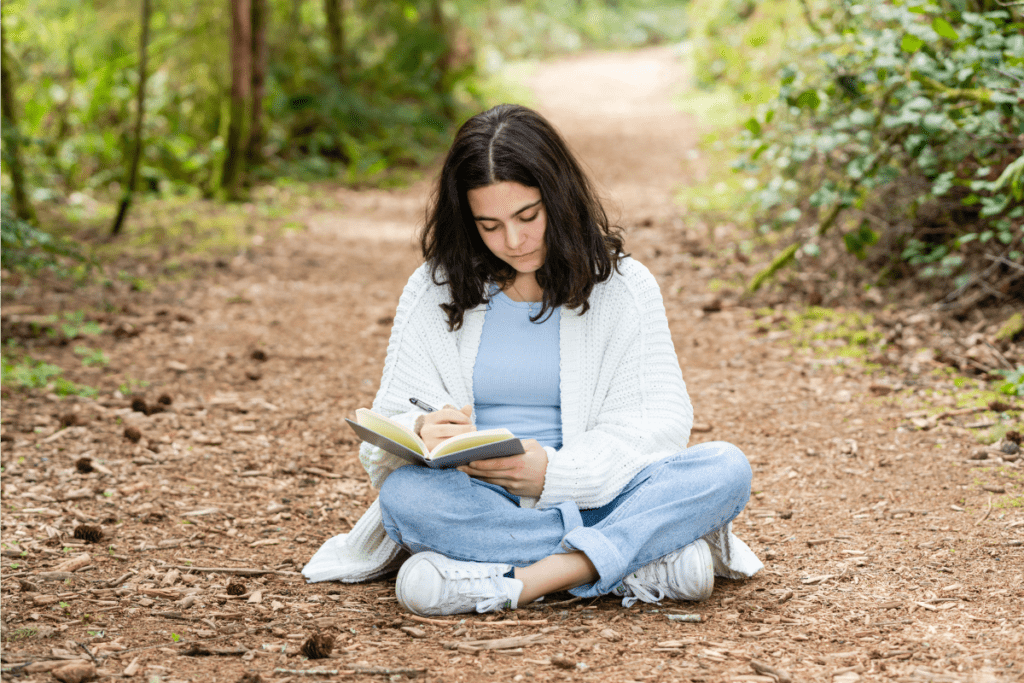 Reflection. Teen in nature journaling